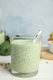 Photo of Green buckwheat smoothie on white wooden table