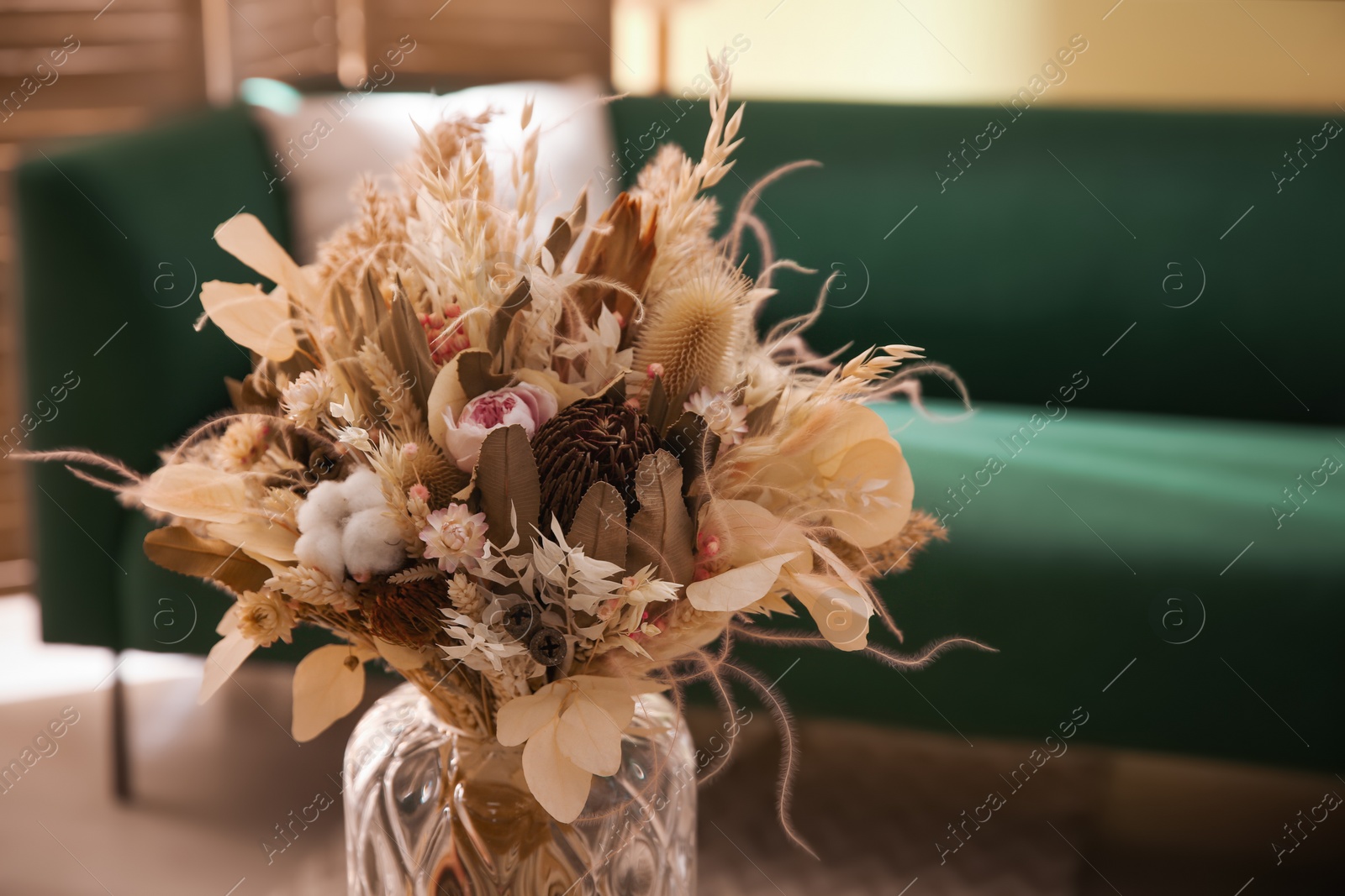 Photo of Bouquet of dry flowers and leaves in living room. Space for text