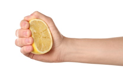 Photo of Woman squeezing lemon half on white background, closeup