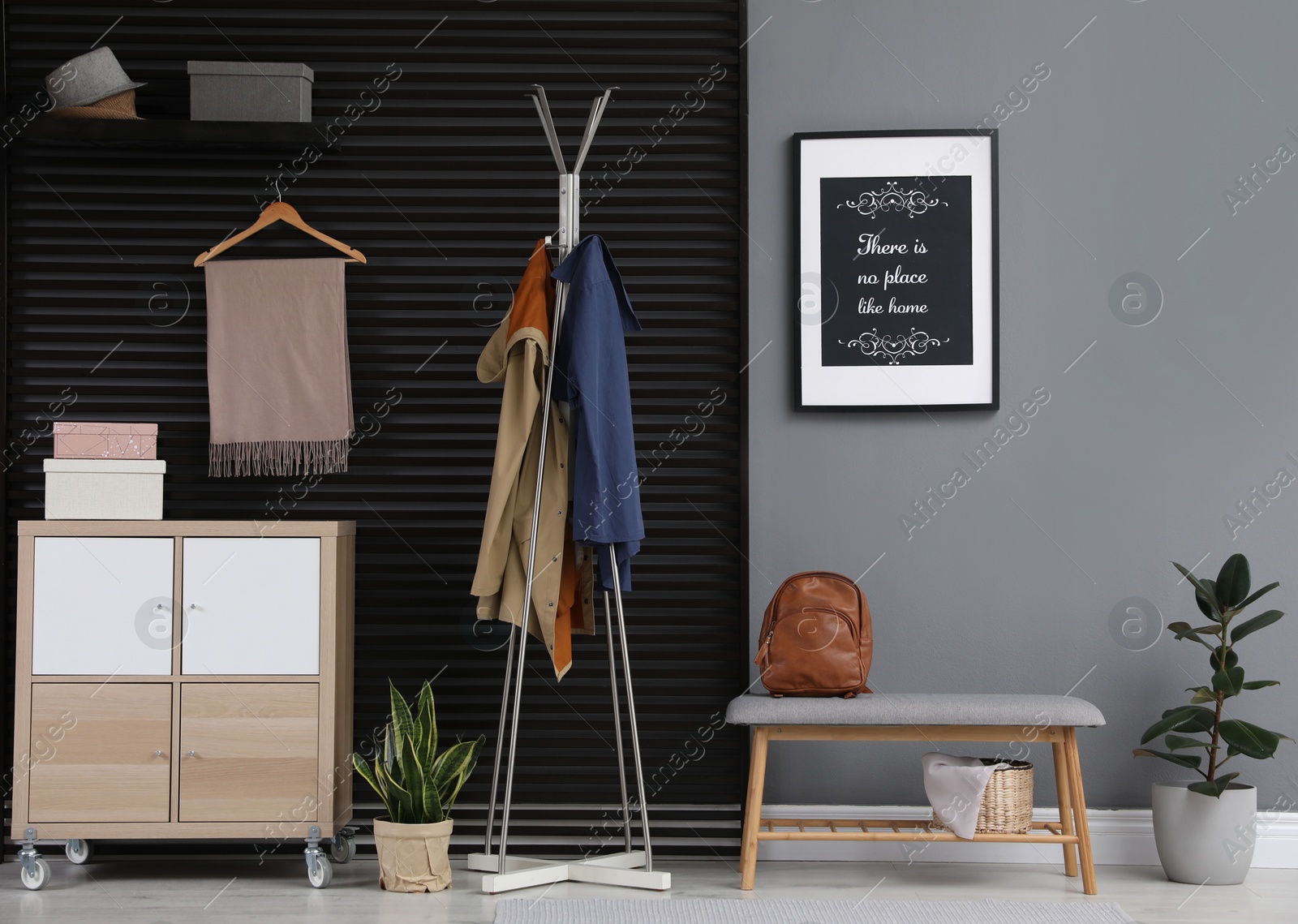 Photo of Hallway interior with stylish furniture, clothes and accessories