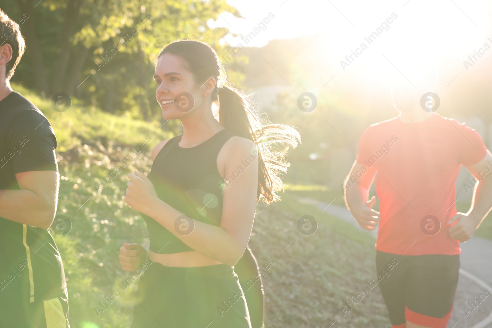 Photo of Group of people running outdoors on sunny day