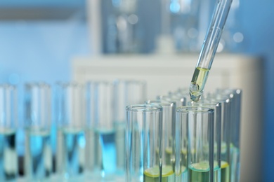 Dripping reagent into test tube with sample at laboratory, closeup. Chemical analysis