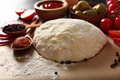 Photo of Pizza dough and products on table, closeup