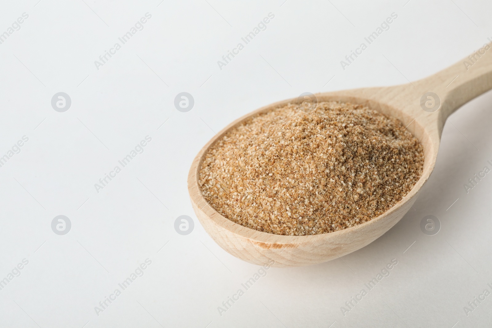 Photo of Spoon of buckwheat flour isolated on white. Space for text