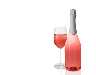 Bottle and glass of delicious rose wine on white background