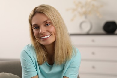 Photo of Portrait of beautiful woman with blonde hair. Attractive lady smiling and looking into camera. Space for text