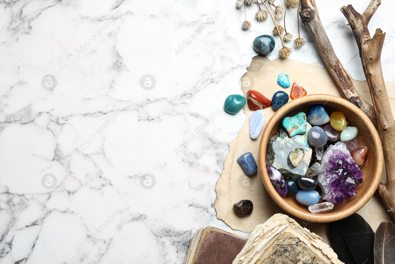 Photo of Flat lay composition with different gemstones on white marble background. Space for text