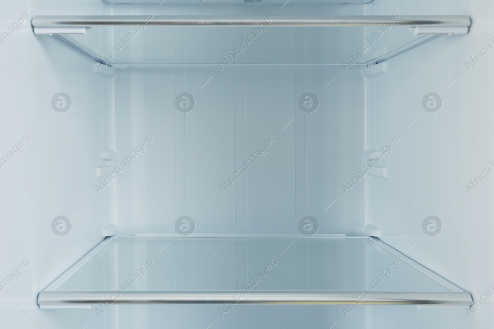 Photo of Shelves of empty modern refrigerator, closeup view