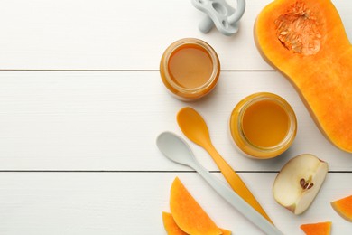 Photo of Tasty baby food in jars, pacifier and ingredients on white wooden table, flat lay. Space for text