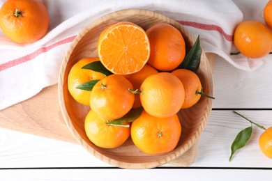 Photo of Fresh ripe tangerines on white wooden table, flat lay