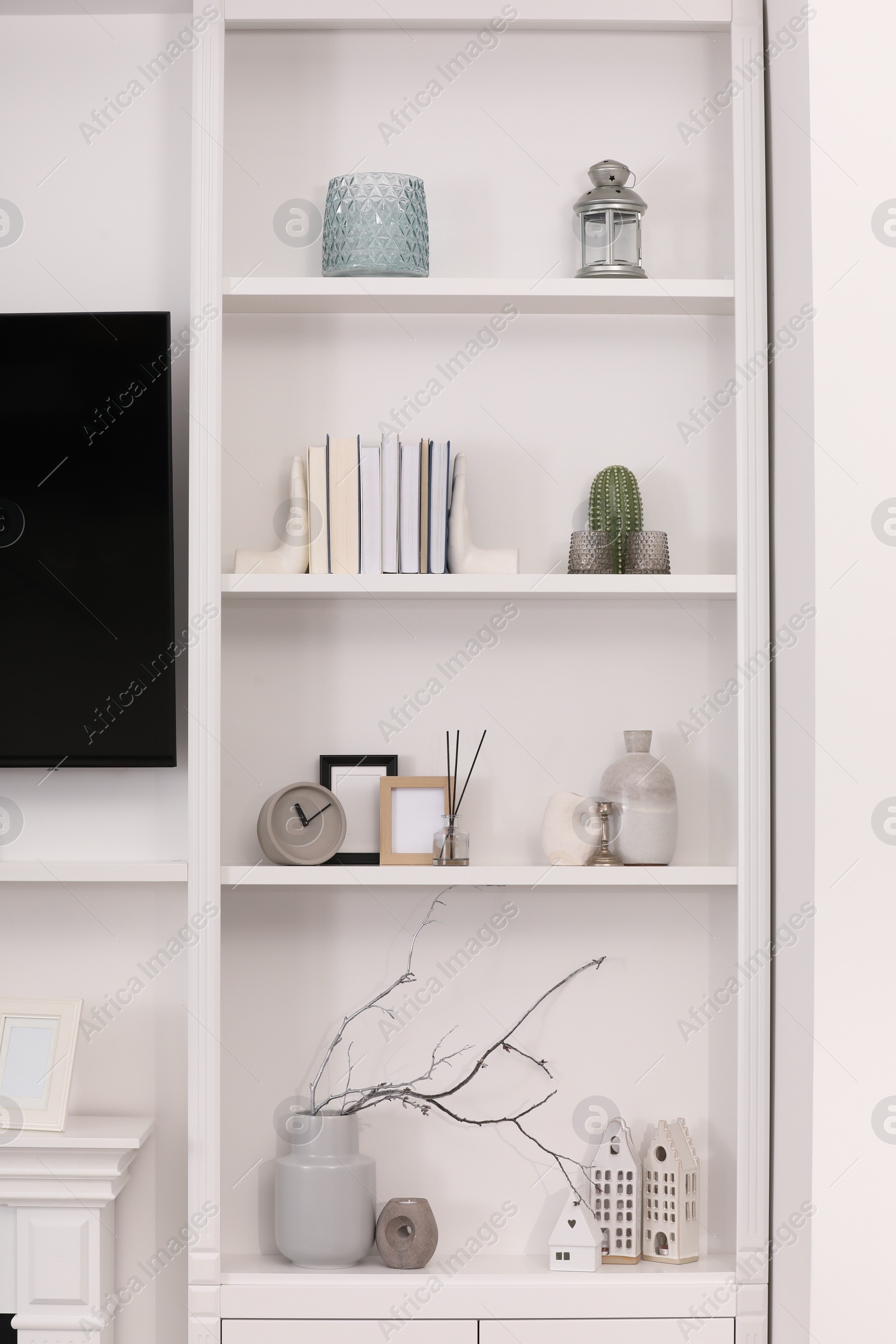 Photo of Stylish shelves with different decor elements in room. Interior design