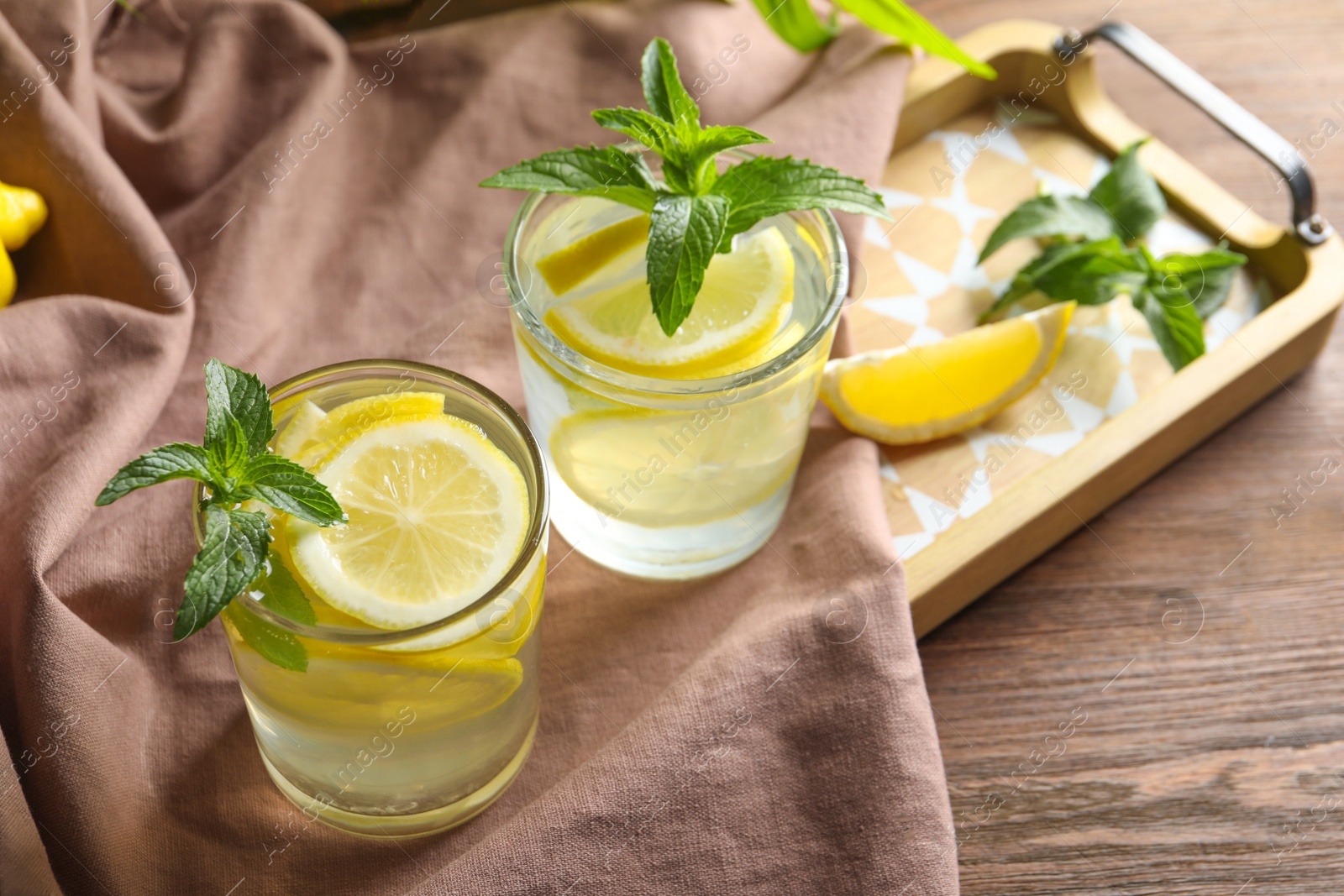 Photo of Natural lemonade with mint in glasses on tray