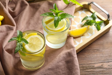 Photo of Natural lemonade with mint in glasses on tray