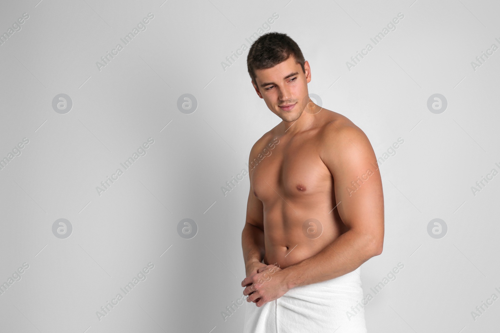 Photo of Man with sexy body on light background. Space for text