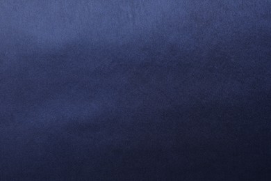 Photo of Texture of dark blue silk fabric as background, top view