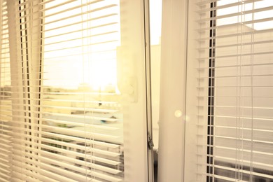 Image of Stylish window with horizontal blinds in room