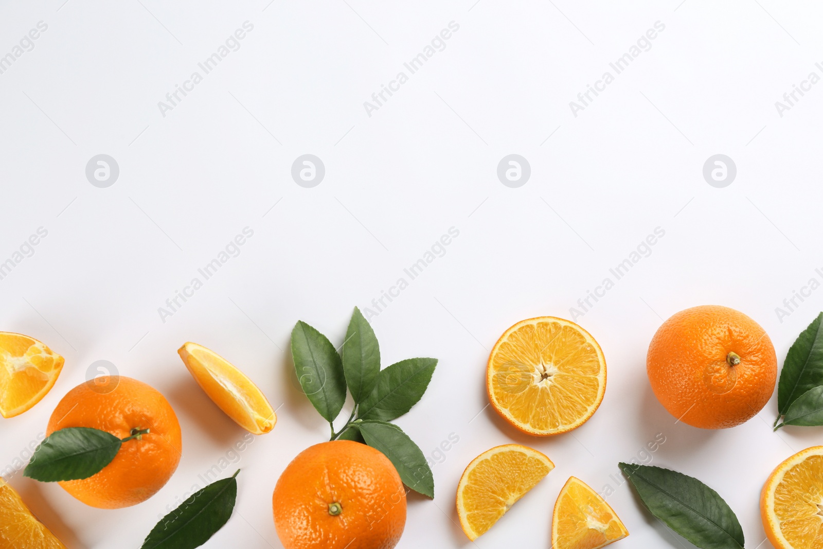 Photo of Delicious oranges on white background, flat lay. Space for text