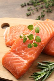 Photo of Fresh raw salmon and ingredients for marinade on wooden table, closeup