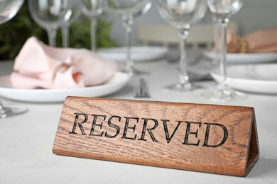 Table setting with RESERVED sign in restaurant