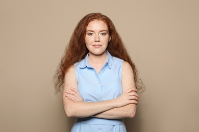 Portrait of young woman with beautiful face on beige background