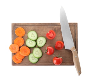 Photo of Wooden board with cut vegetables and chef knife isolated on white, top view