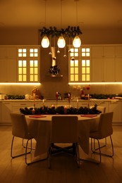 Photo of Cozy spacious kitchen decorated for Christmas. Interior design