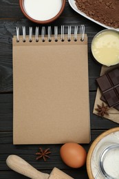 Blank recipe book and different ingredients on black wooden table, flat lay. Space for text