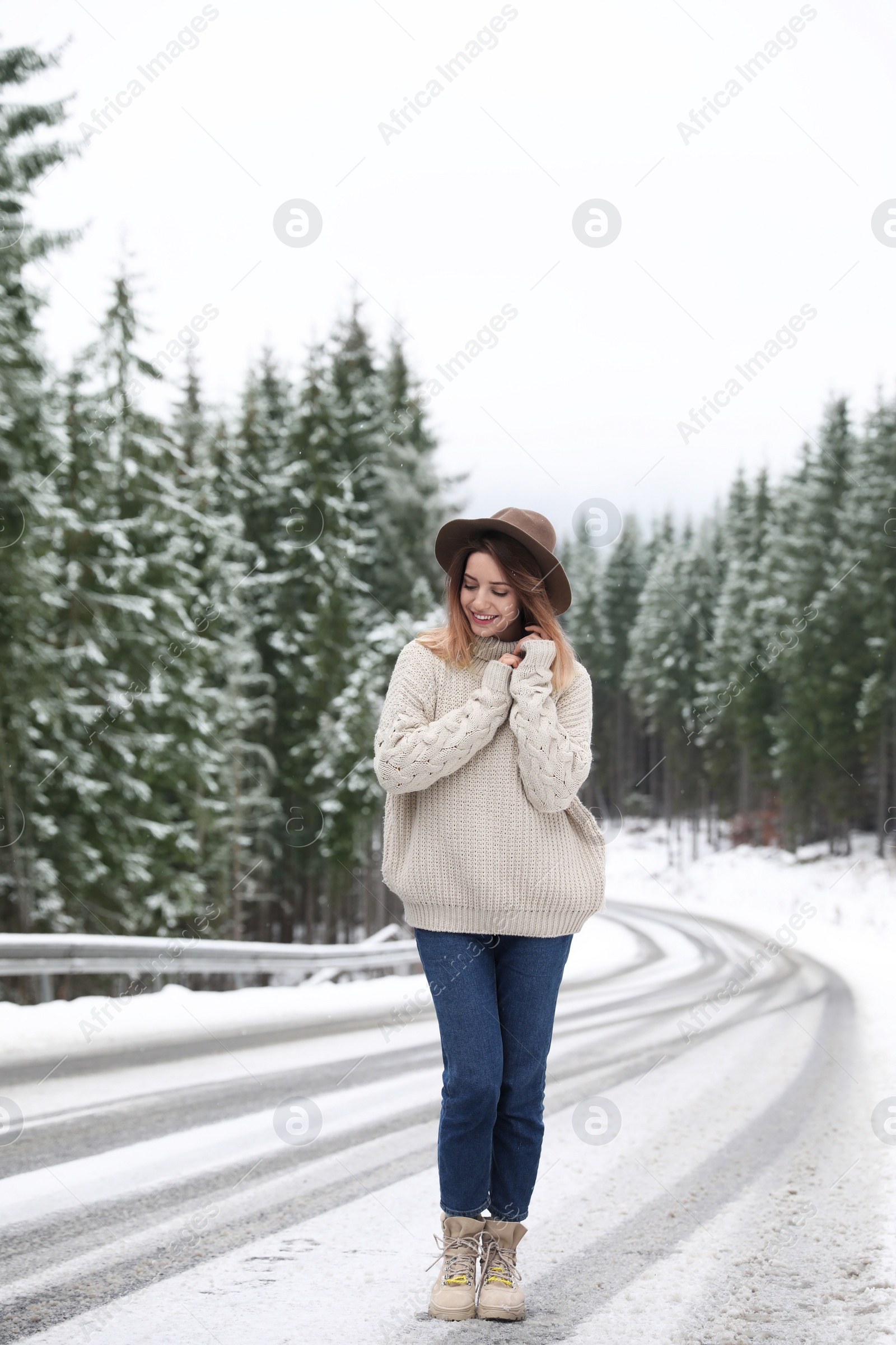 Photo of Young woman walking near snowy forest. Winter vacation