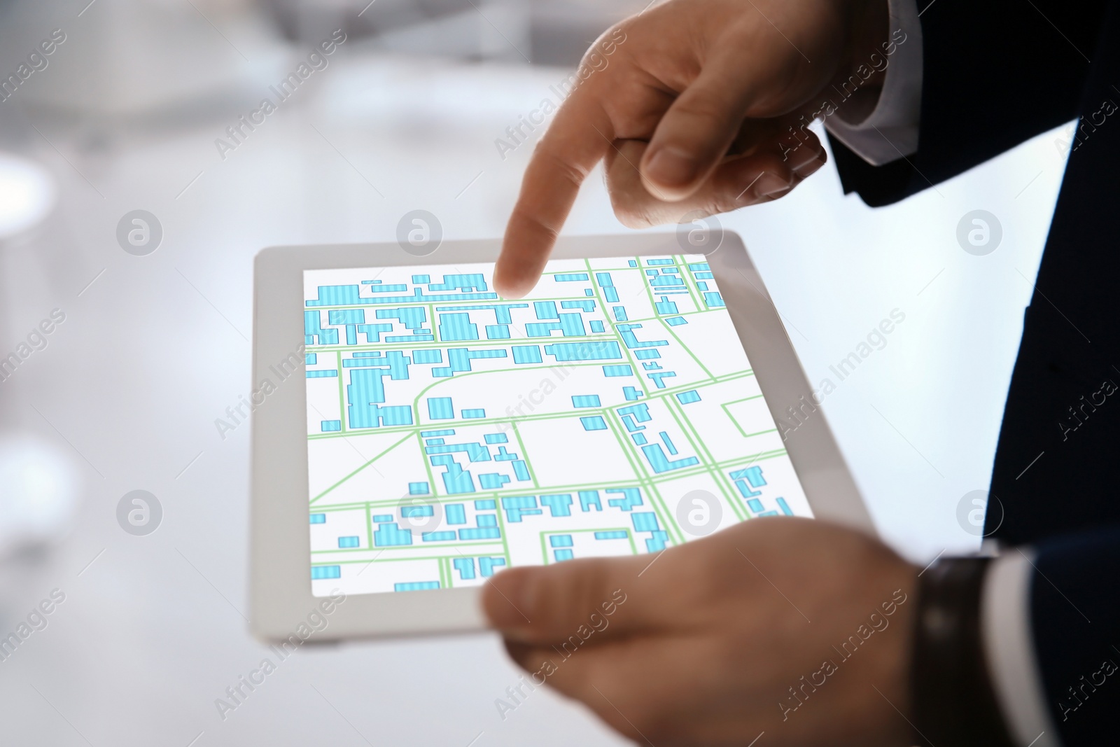 Image of Man analyzing cadastral map on tablet indoors, closeup 
