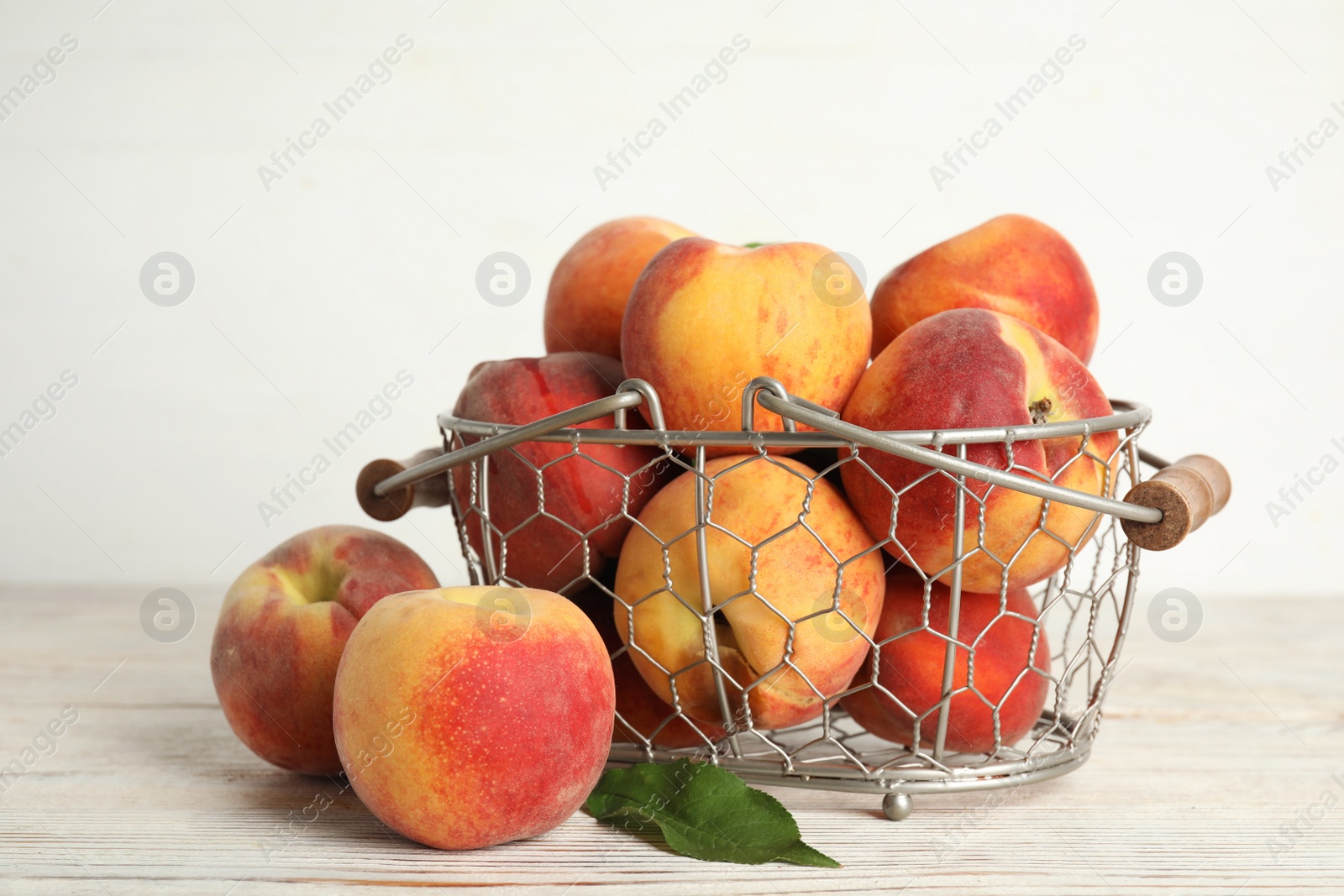 Photo of Fresh ripe juicy peaches on white wooden table