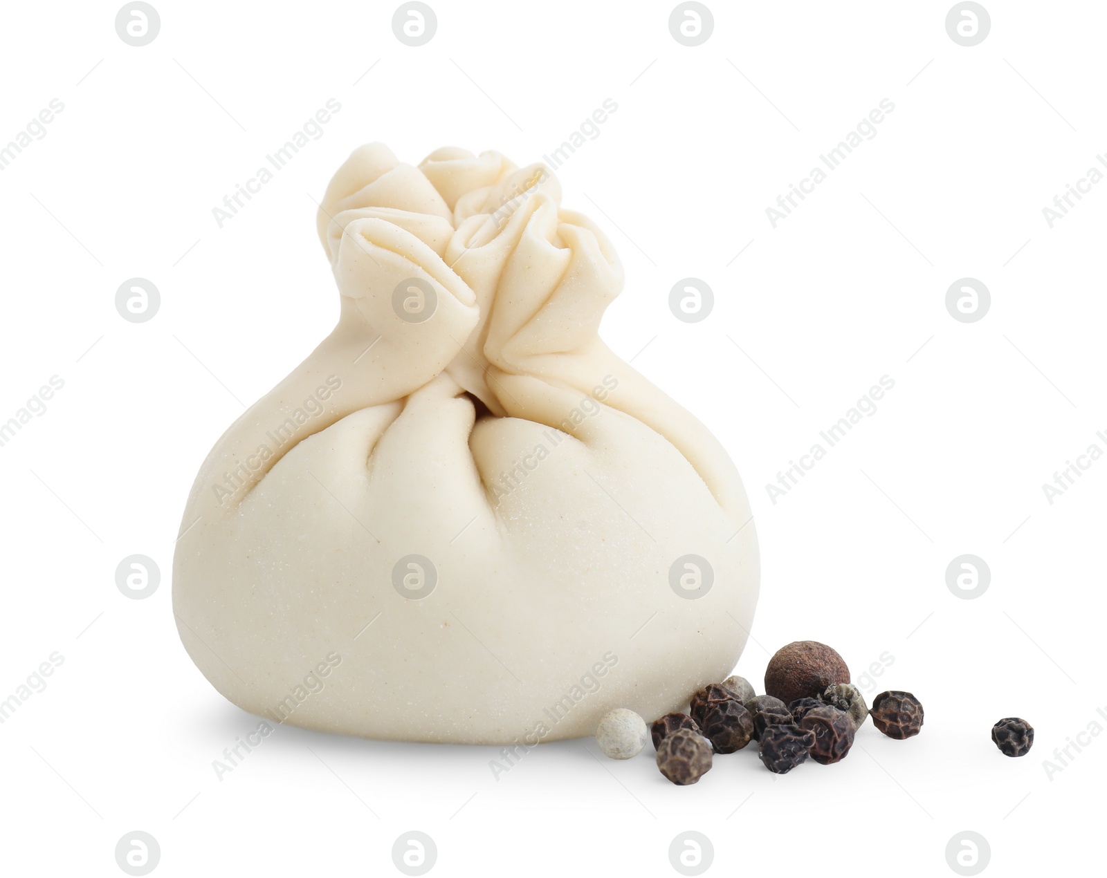 Photo of Uncooked khinkali (dumpling) and peppercorns isolated on white. Georgian cuisine