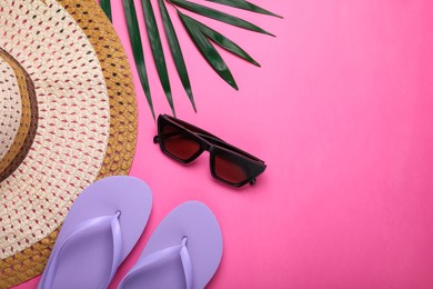 Photo of Flat lay composition with beach accessories on pink background. Space for text