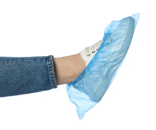 Photo of Woman wearing blue shoe cover onto her sneaker against white background, closeup