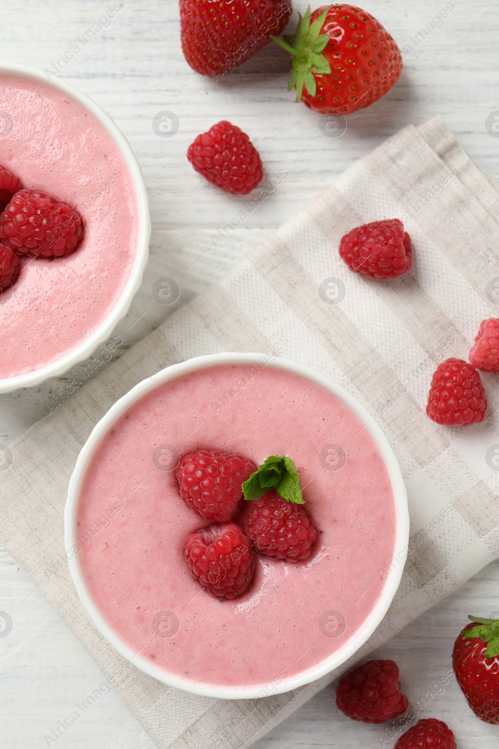 Photo of Delicious raspberry mousse with mint on white wooden table, flat lay