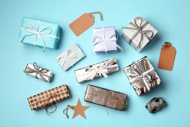 Flat lay composition with beautiful gift boxes and tags on color background