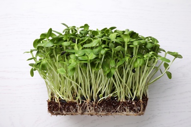 Photo of Fresh organic microgreen on white table, top view