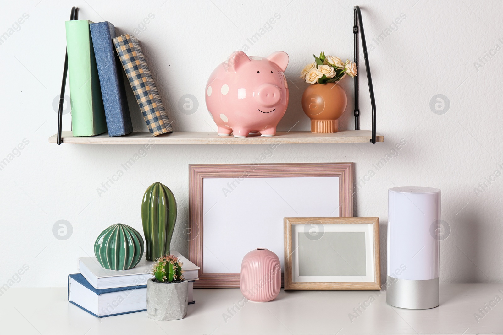 Photo of Cute piggy bank on shelf indoors. Stylish interior element