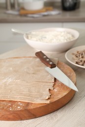 Photo of Making homemade soba (buckwheat noodles) on wooden table in kitchen