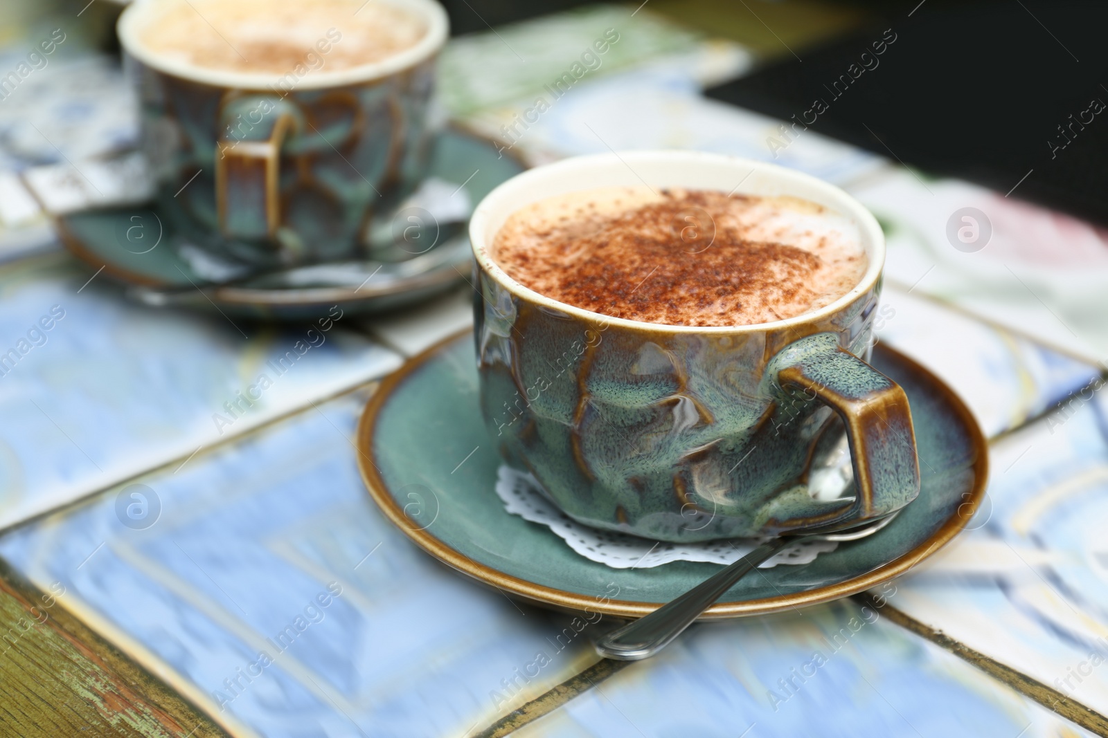 Photo of Cup of fresh aromatic coffee on table at cafe