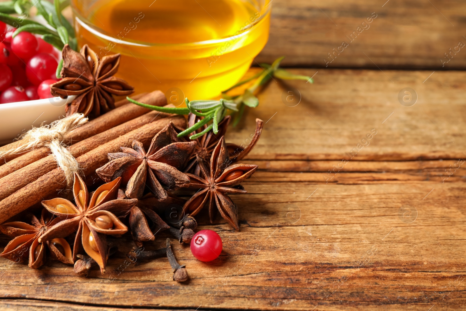 Photo of Composition with mulled wine ingredients on wooden table, closeup. Space for text