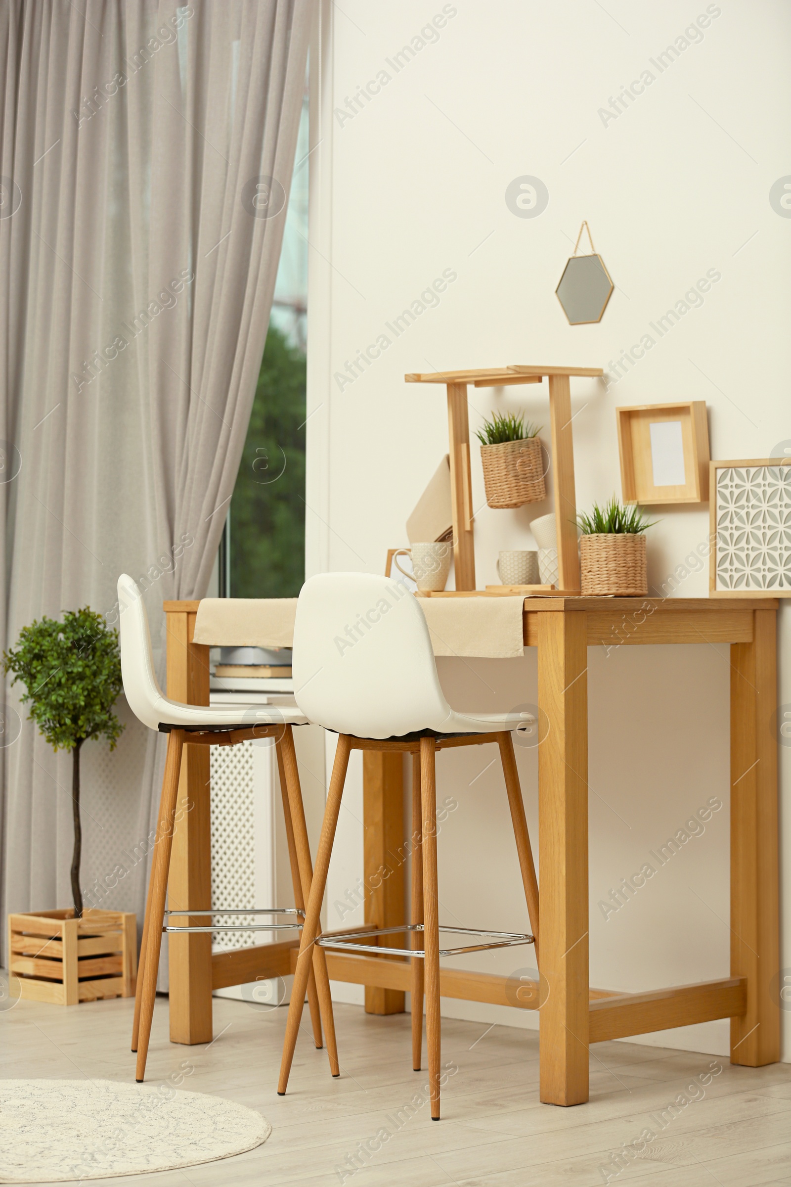 Modern room interior with wooden dining table Photo of Modern room interior with wooden dining table