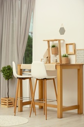 Photo of Modern room interior with wooden dining table