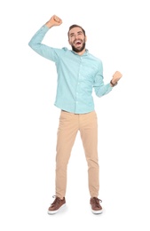 Photo of Young man celebrating victory on white background