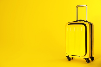 Photo of Stylish suitcase on color background. Space for text