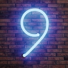 Image of Glowing neon number 9 sign on brick wall