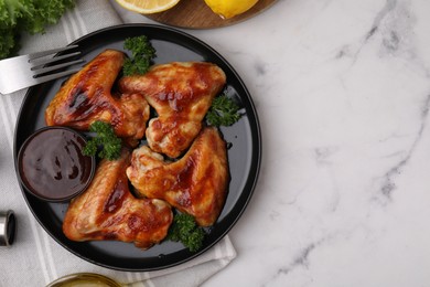 Photo of Flat lay composition with marinade and chicken wings on white marble table. Space for text