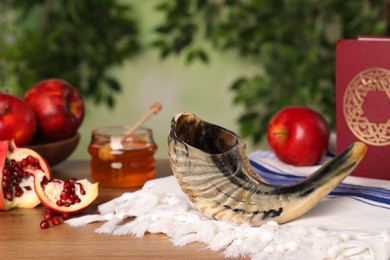 Photo of Composition with Rosh Hashanah holiday symbols on wooden table