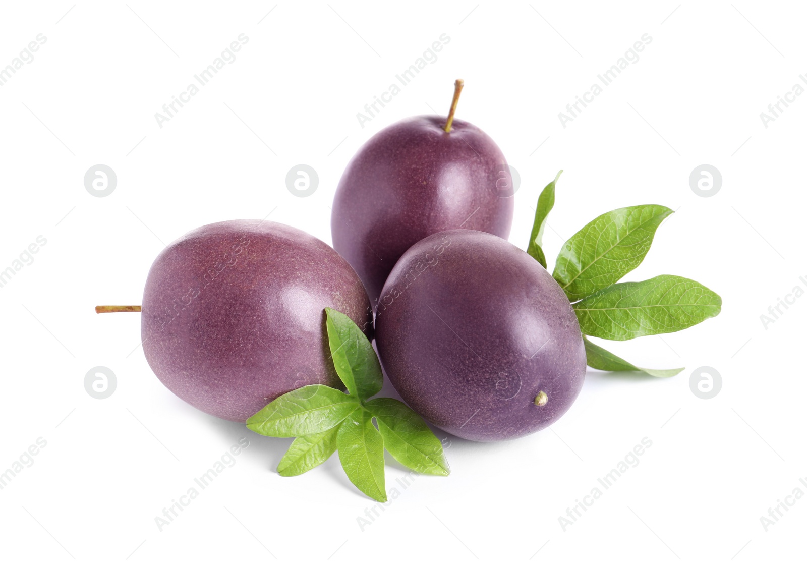 Photo of Ripe passion fruits with leaves isolated on white