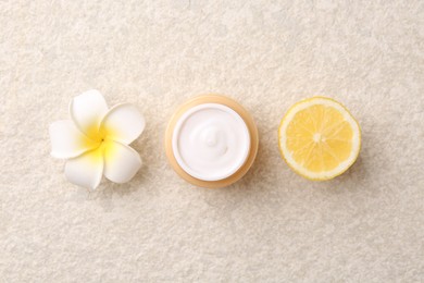 Photo of Body care. Moisturizing cream, sea salt and flower on light textured table, flat lay