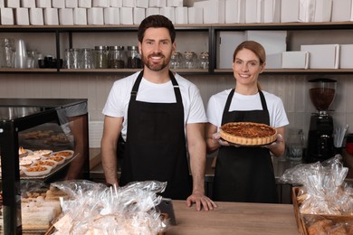 Photo of Sellers with freshly baked quiche in bakery shop